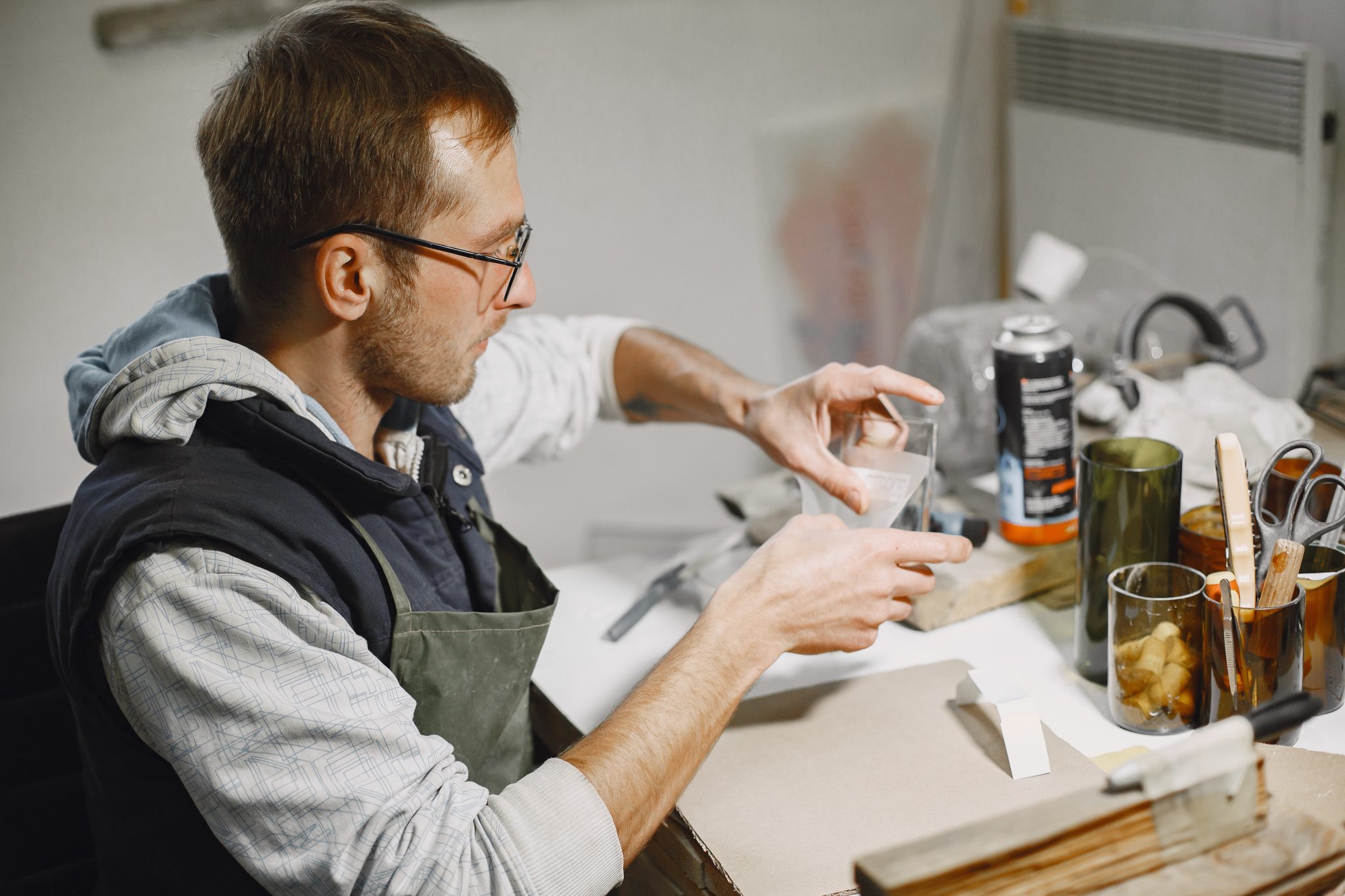 a man sticks stickers on glasses