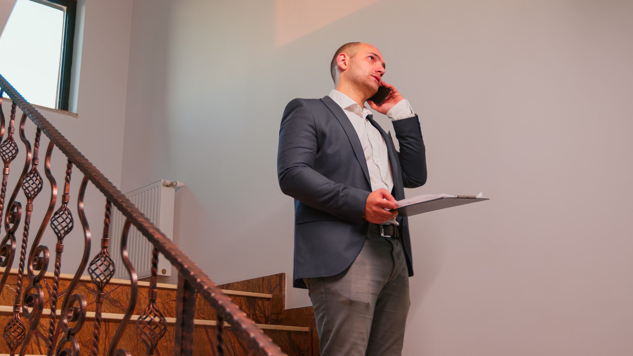 furious businessman talking on smartphone